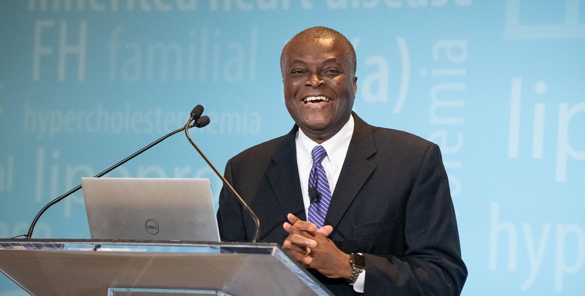 Man behind a podium giving a presentation