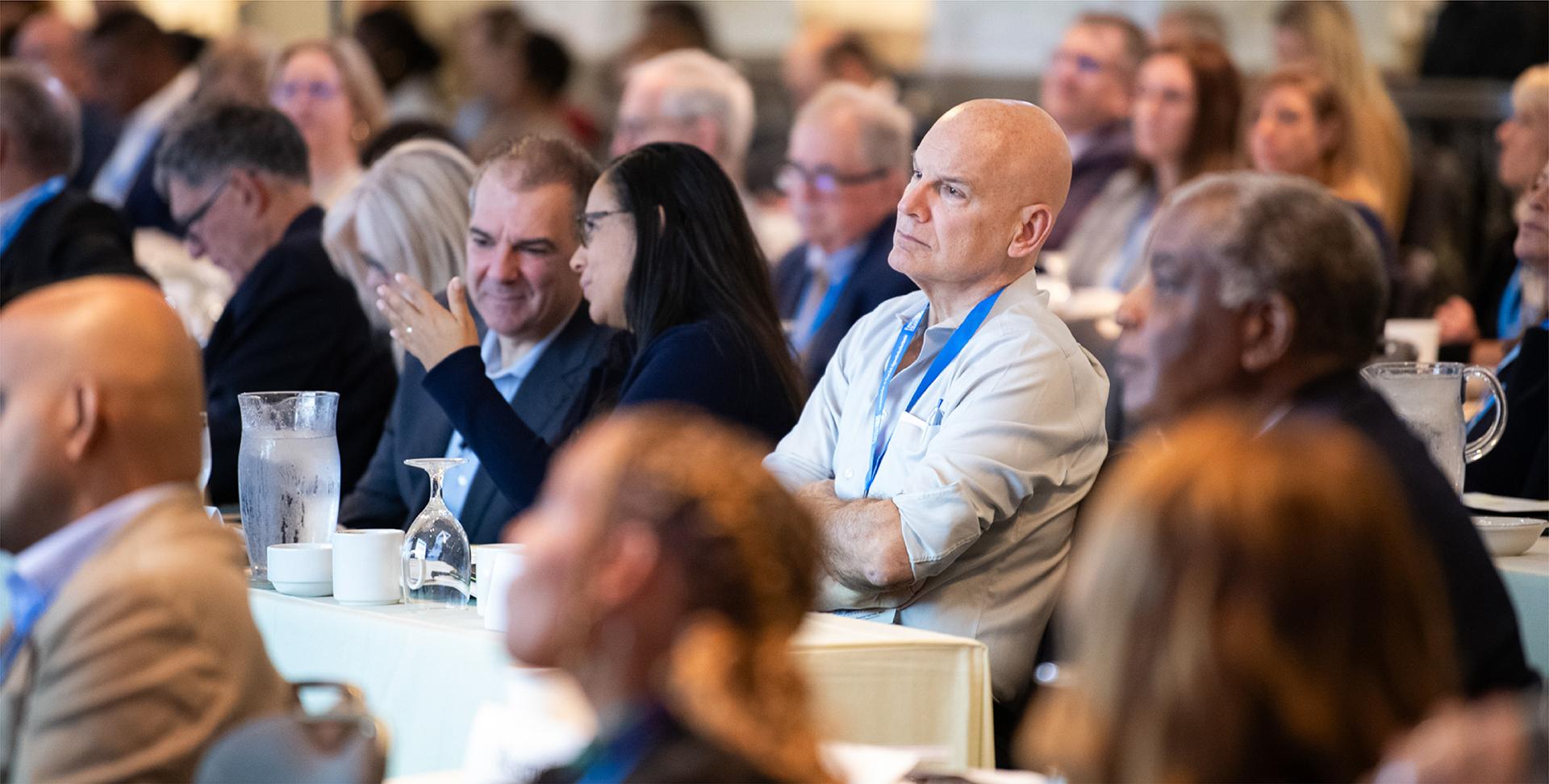 Group of people sitting and listening to a presentation
